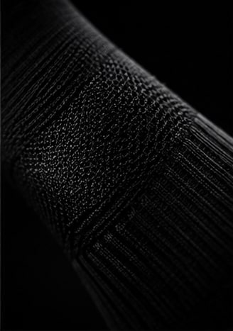 Tejido acanalado y zona de compresión de una PACE Performance Sock.